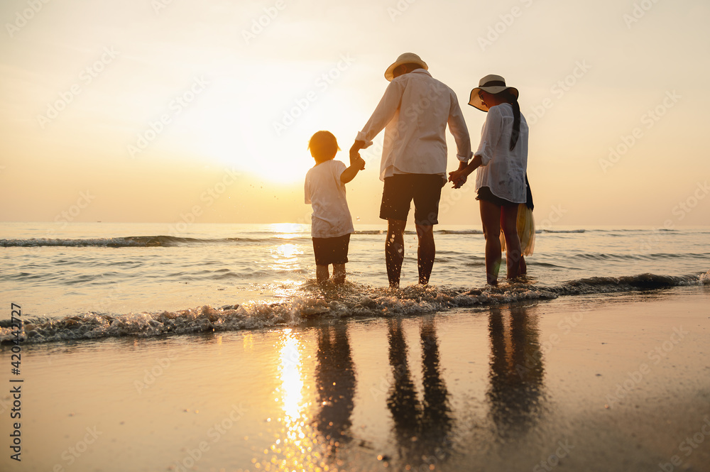 Happy asian family at consisting father, mother,son and daughter having fun playing beach in summer vacation on the beach.Happy family and vacations concept.