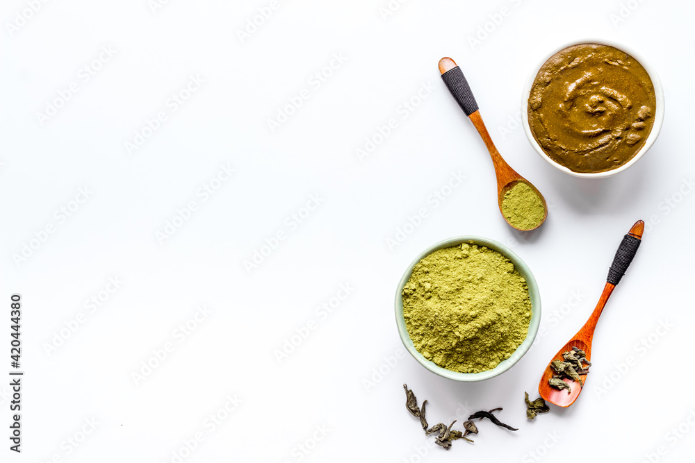Henna powder in wooden bowl with green leaves. Herbal natural hair dye Henna powder in wooden bowl with green leaves. Herbal natural hair dye