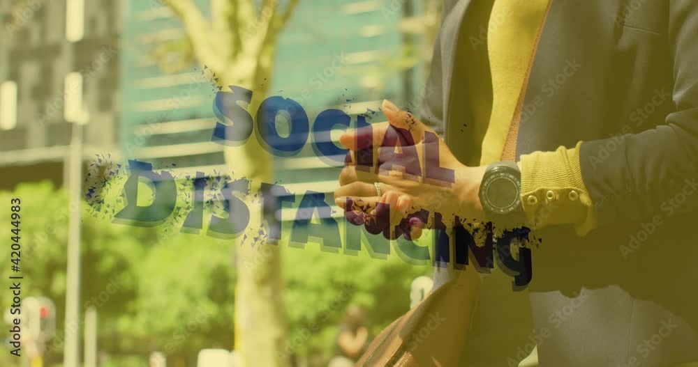 Animation of social distancing text over woman disinfecting her hands Animation of social distancing text over woman disinfecting her hands