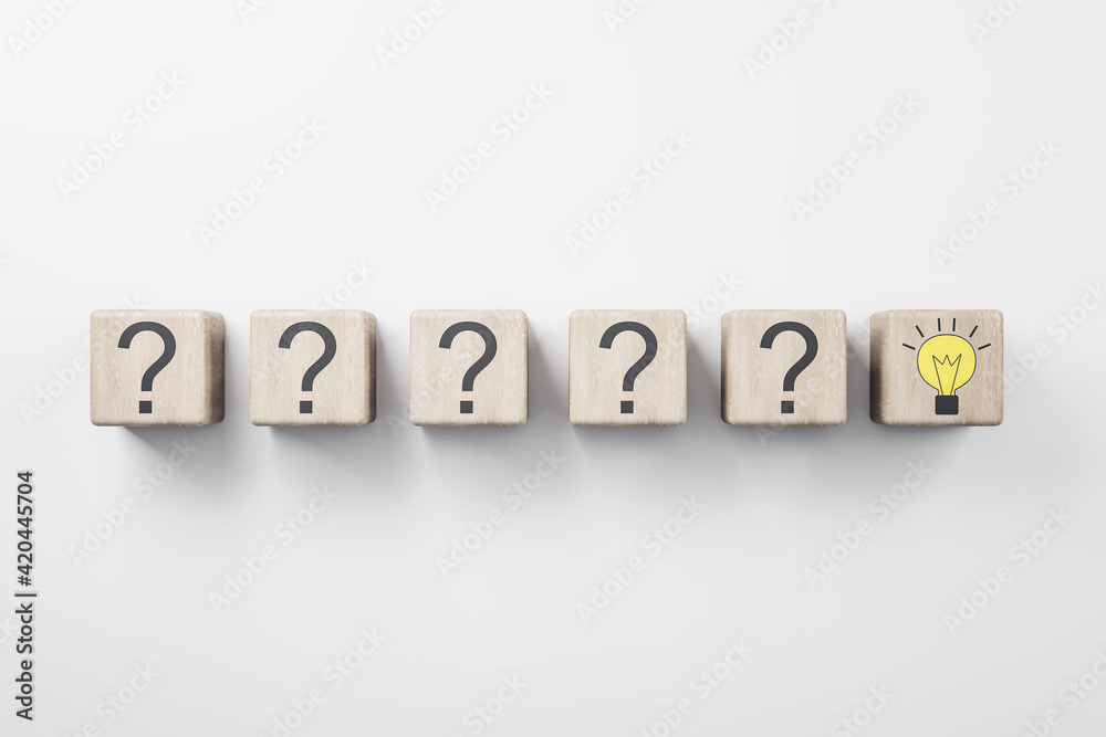 New idea concept with row of wooden cubes with question mark and one with yellow light bulb New idea concept with row of wooden cubes with question mark and one with yellow light bulb