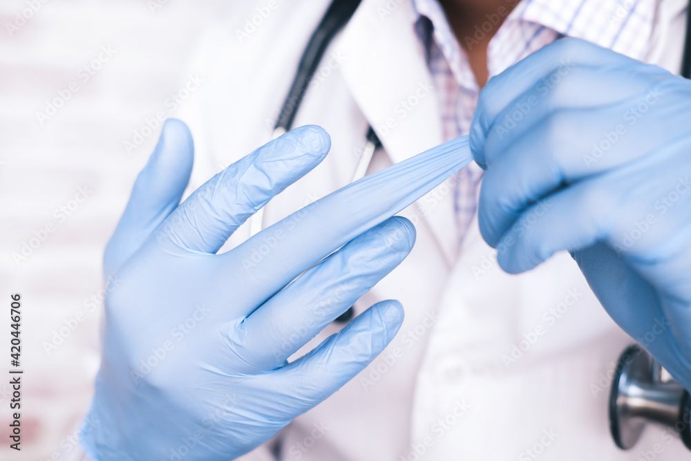 doctor wears medical latex gloves, close up doctor wears medical latex gloves, close up
