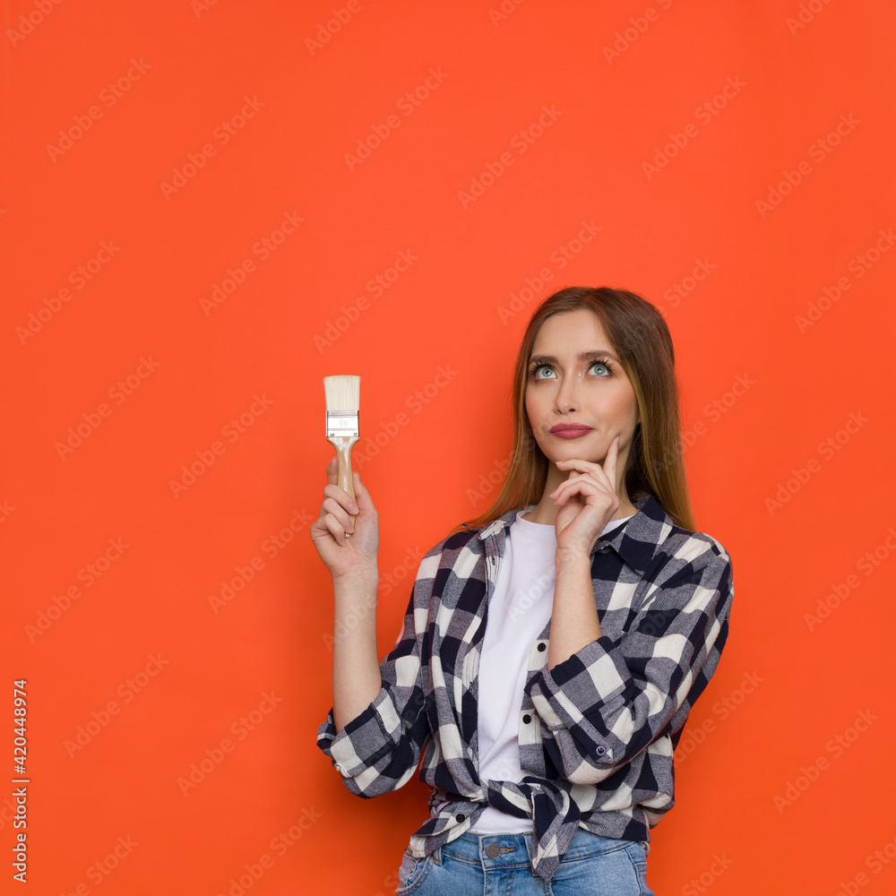 Worried Young Woman Is Holding Paintbrush And Looking Up Worried Young Woman Is Holding Paintbrush And Looking Up