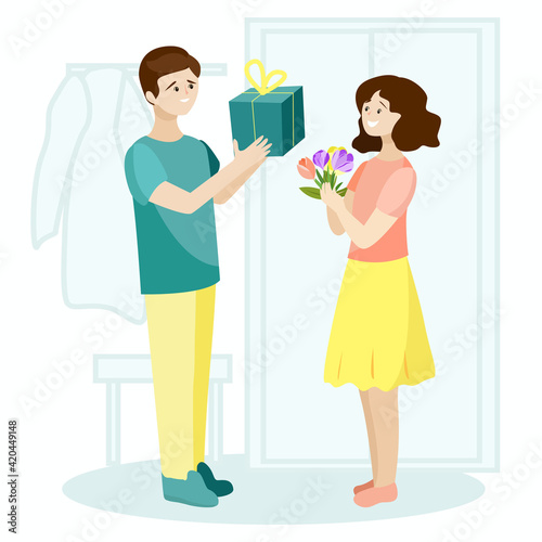 A young man gives a girl a gift and flowers