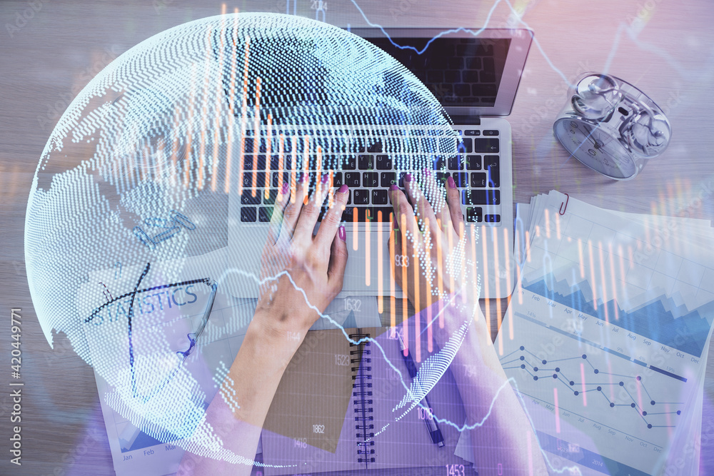 Double exposure of woman hands working on computer and forex graph hologram drawing. Top View. Financial analysis concept. Double exposure of woman hands working on computer and forex graph hologram drawing. Top View. Financial analysis concept.