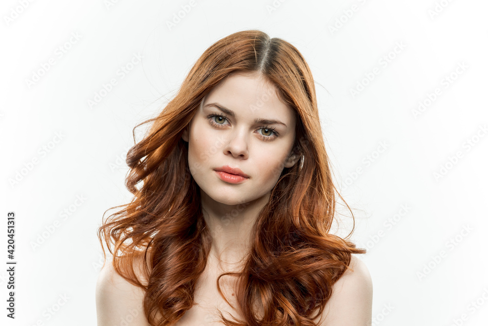 Fototapeta premium cheerful woman attractive look naked shoulders loose hair light background