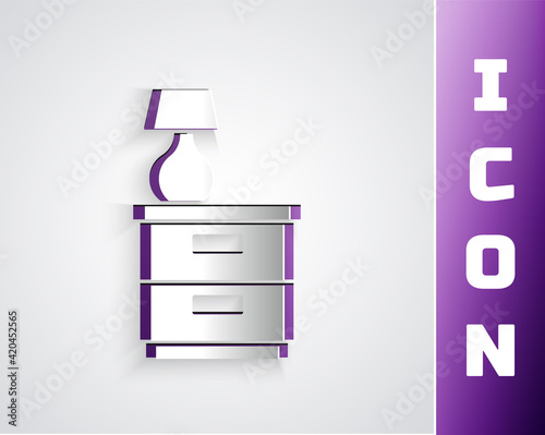 Paper cut Furniture nightstand with lamp icon isolated on grey background. Paper art style. Vector