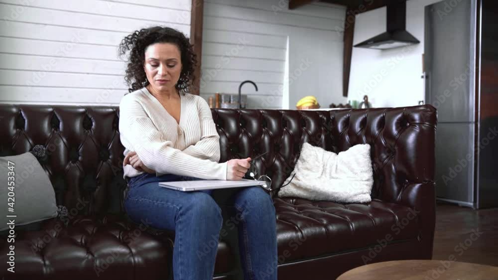 African american freelancer with eyeglasses using laptop at home African american freelancer with eyeglasses using laptop at home