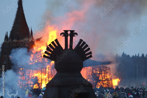 Symbol of Russia: two-headed eagle. Maslenitsa 2021. Traditional national holiday, folk game in Nikola-Lenivets, Kaluga region, Russia. Russian landmark. Politics, political crisis in country. Holiday