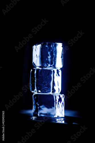 Square ice cubes on a black background