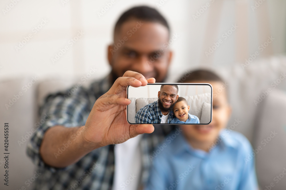 African Father And Son Making Selfie On Smartphone At Home
