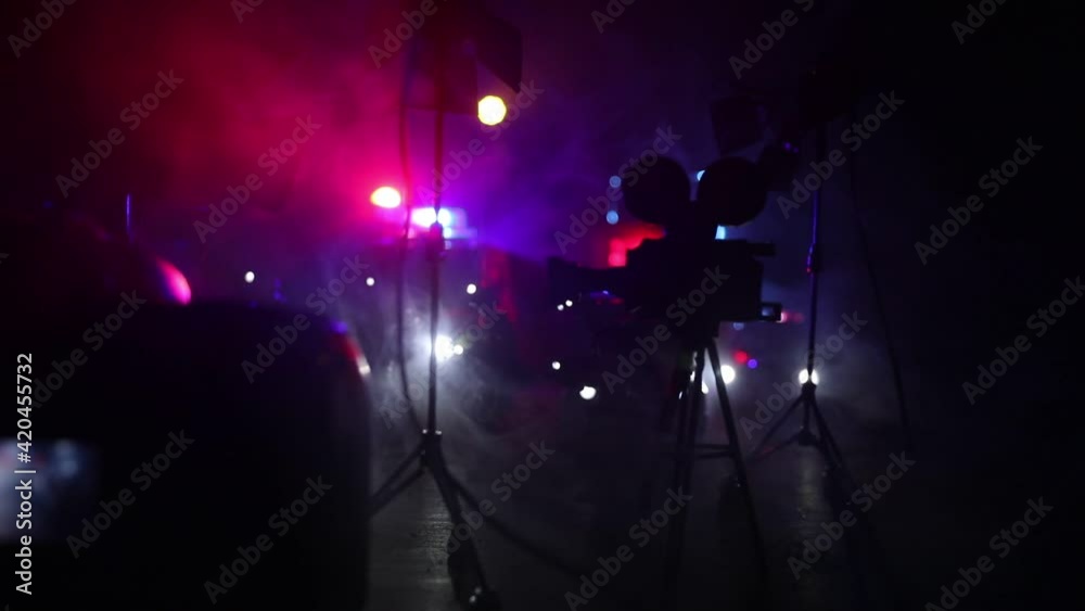 Action movie concept. Police cars and miniature movie set on dark toned background with fog. Police car chasing a car at night. Scene of crime accident. Selective focus Action movie concept. Police cars and miniature movie set on dark toned background with fog. Police car chasing a car at night. Scene of crime accident. Selective focus