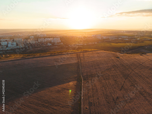 sunset landscape of sage field and city