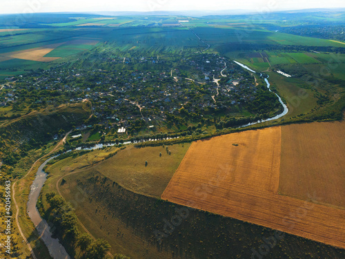 village at river curve at sunny day