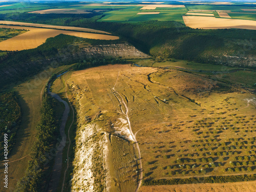 green hills, wheat fields and river curve