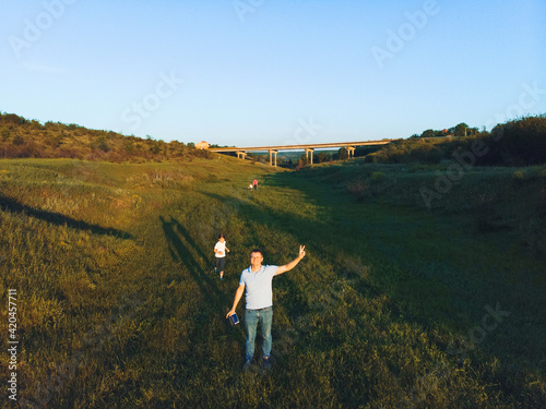 happy man with family walking under bridge