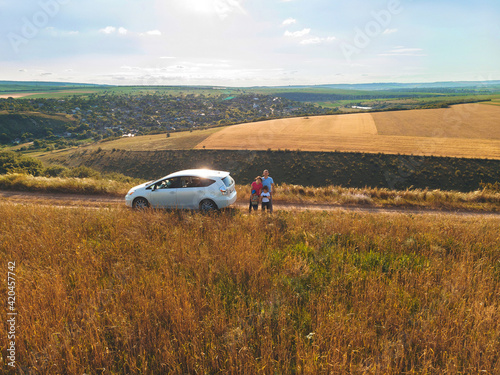 family at white car