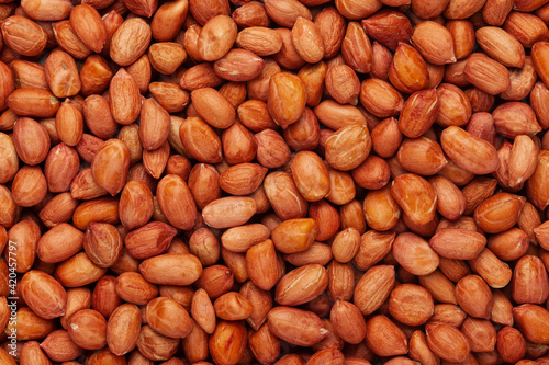 Close-up of organic red-brown peanuts (Arachis hypogaea) Full Frame Background. Top View
