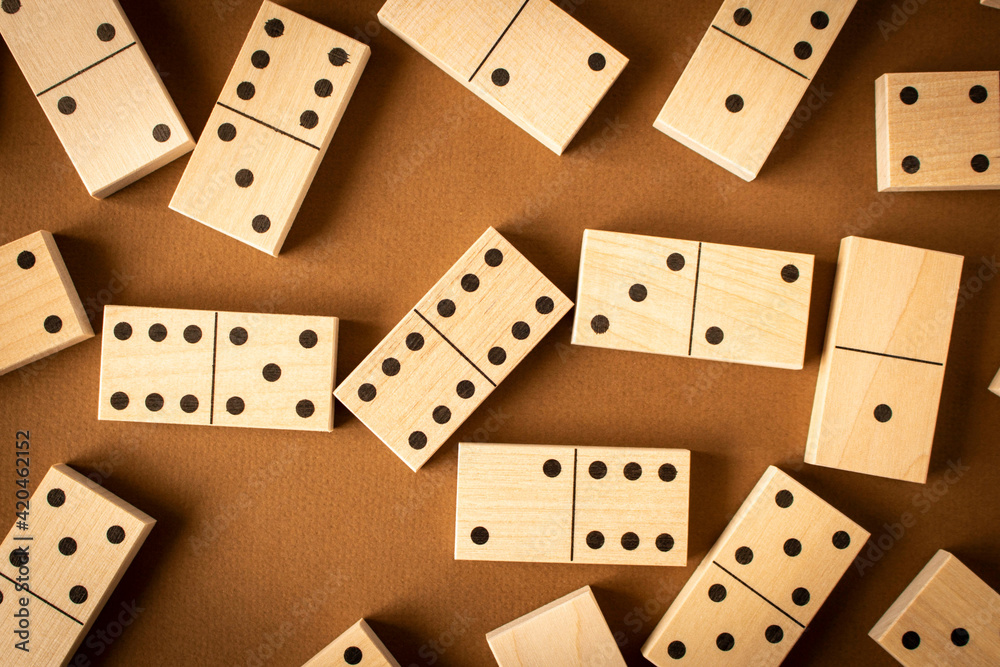 A game of dominoes on a brown background. Close-up. Selective focus. A game of dominoes on a brown background. Close-up. Selective focus.
