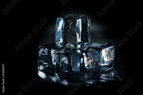 Square ice cubes on a black background