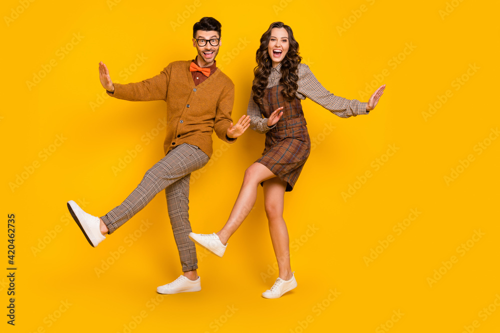 Full size photo of happy funky couple boyfriend girlfriend dance good mood isolated on yellow color background