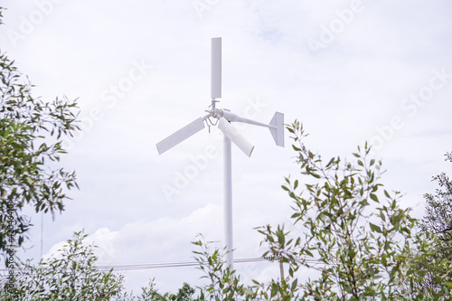 Wind turbines white sky background © romeoanimore