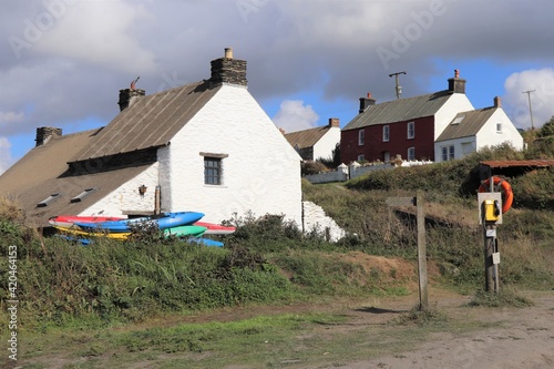 White Buildings and Colorful Kayaks in Abereiddy in Pembrokeshire, Wales, UK photo