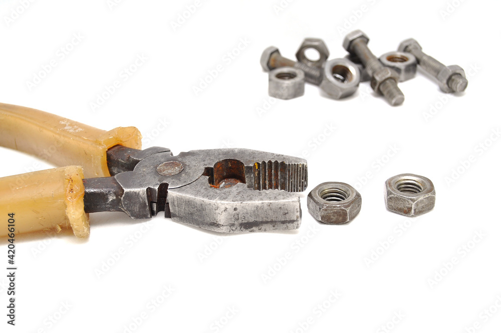 Rusty pliers bolts and nuts on white background close up Rusty pliers bolts and nuts on white background close up