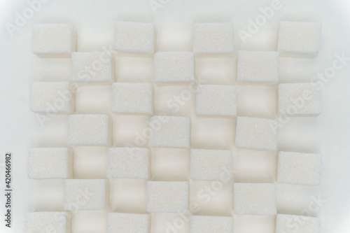 sugar cubes staggered glucose sweets ingredient light background © SHOTPRIME STUDIO
