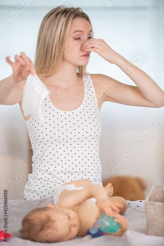 mother holding her baby smelly nappy