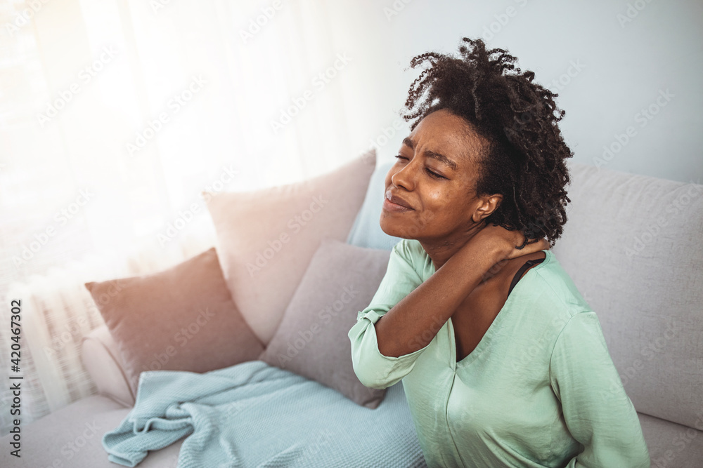 Too much stress, not enough rest. Shot of a young businesswoman experiencing stress. Young Businesswoman Suffering From Neckache. Young woman at home Too much stress, not enough rest. Shot of a young businesswoman experiencing stress. Young Businesswoman Suffering From Neckache. Young woman at home