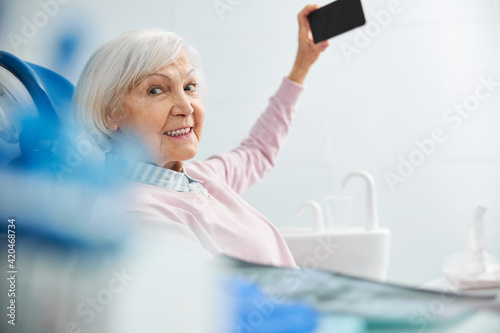 Aged female turning away from cell phone