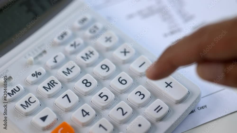 Close up male hands using calculator to calculate his income and expenses. In his hand there were bills to pay a lot in debt.
Close up male hands using calculator to calculate his income and expenses. In his hand there were bills to pay a lot in debt.