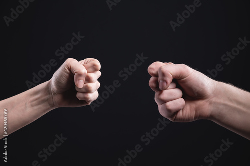 Game stone paper scissors on a dark background. The male and female hand are competing. Business competition