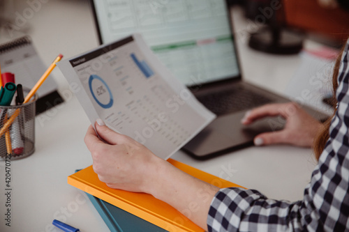 Woman hand holding business documents. Marketing market growth