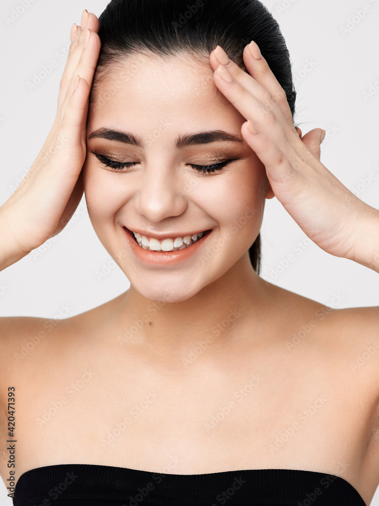 brunette with bare shoulders closed eyes cosmetics glamor