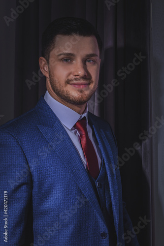 A stylish portrait of the groom preparing for the wedding ceremony.