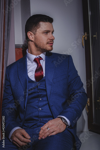 A stylish portrait of the groom preparing for the wedding ceremony.
