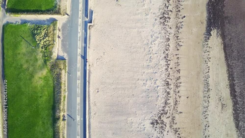 Birds Eye Aerial View Of Sandy Beach Front And Green Grass On A Bright Sunny Day Birds Eye Aerial View Of Sandy Beach Front And Green Grass On A Bright Sunny Day