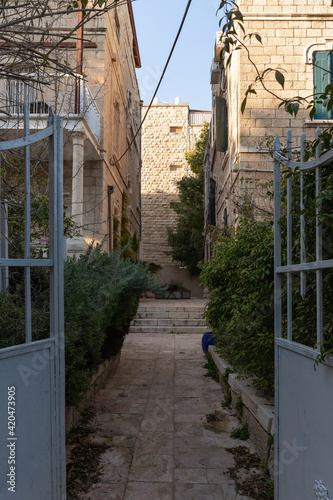 Evening  view of the quiet, green Hovevei Tsiyon Street in the old Jerusalem district Talbia - Komiyum in Jerusalem, Israel photo