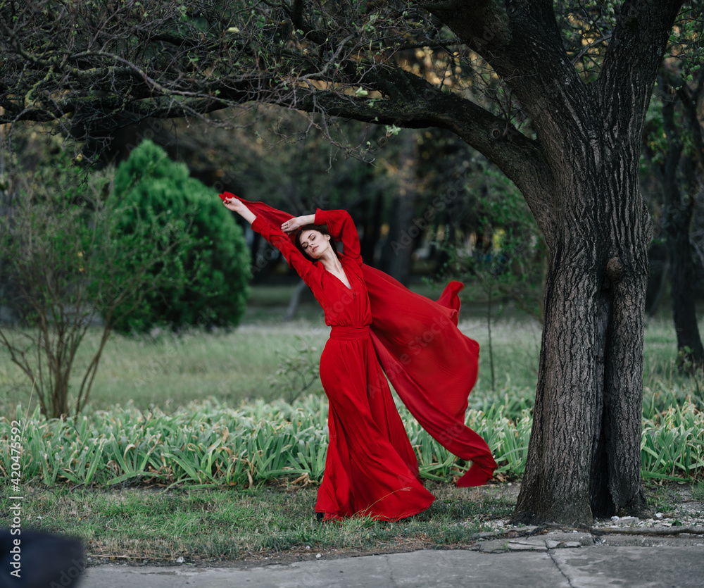 elegant woman in red dress posing near tree luxury summer elegant woman in red dress posing near tree luxury summer