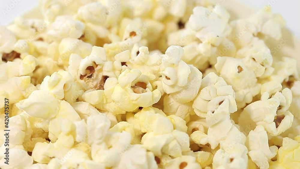 Popcorn salted corn, cooked, in white, bowl, rotation clockwise, turning, close-up. Popcorn salted corn, cooked, in white, bowl, rotation clockwise, turning, close-up.