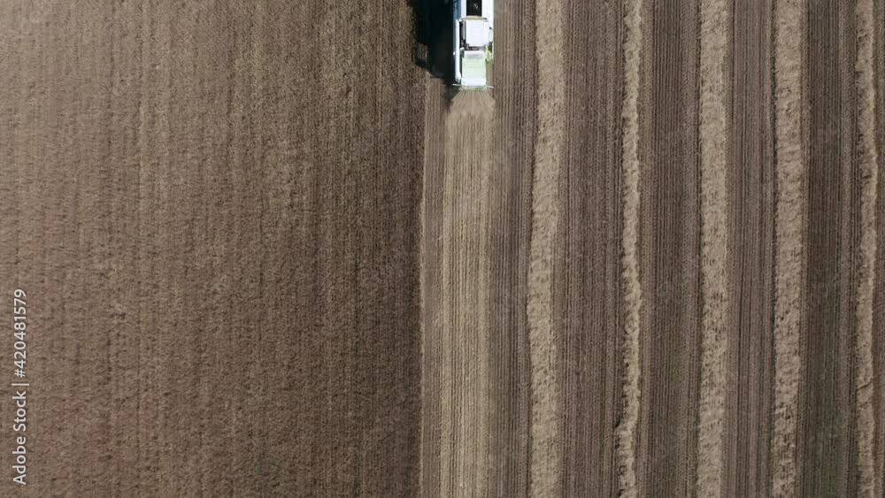 Aerial view of combine harvesting wheat on the field. Agriculture scene. Aerial view of combine harvesting wheat on the field. Agriculture scene.