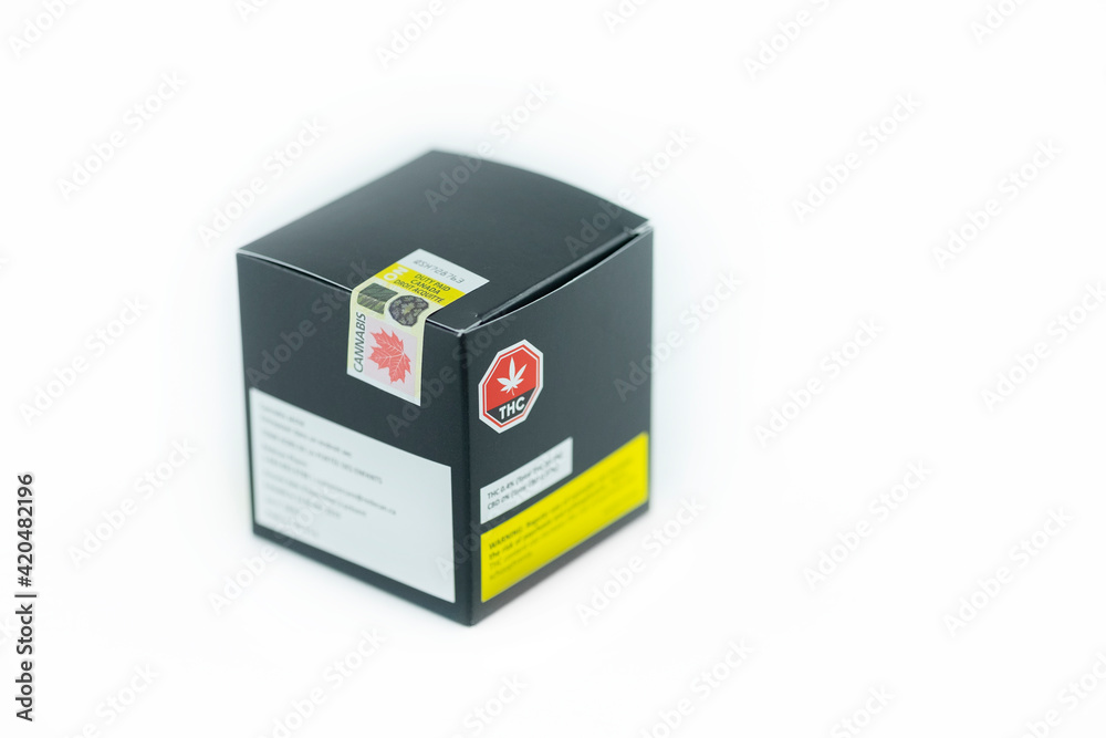 Closeup macro package of legal cannabis marijuana weed for recreational purpose with official government excise stamp label duty paid, white background. Selective focus. Closeup macro package of legal cannabis marijuana weed for recreational purpose with official government excise stamp label duty paid, white background. Selective focus.