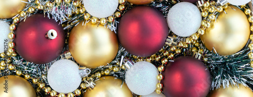 Gold, white and red Christmas balls with gold Christmas beads. Christmas background. New Year or Xmas concept. Top view.