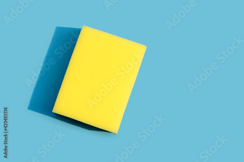 Dishwashing sponge on blue background.