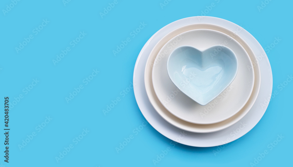 Stack of dishes on blue background. Stack of dishes on blue background.