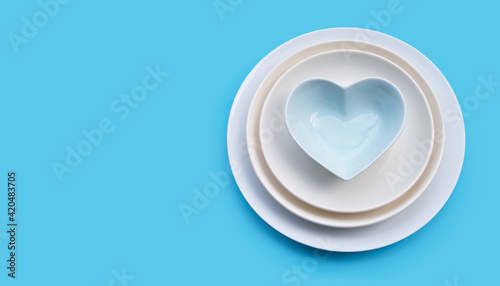 Free Download Stack of dishes on blue background. - GFXLoad
