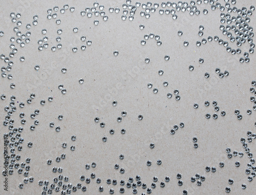 rhinestones on a gray background, top photo. design for text
