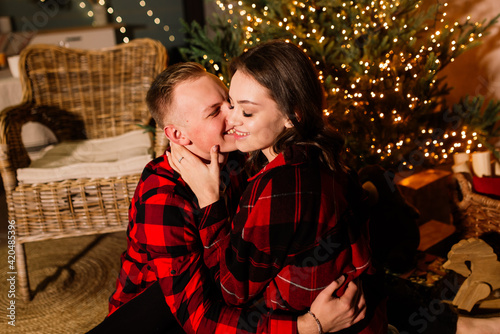 Happy Couple with Christmas and New Year Gift at Home. Smiling Family Together. Christmas tree