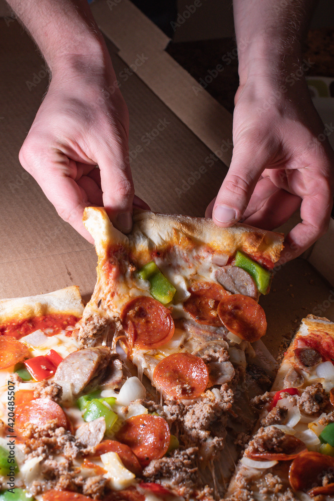 Holding pizza slice, take out, delivery Holding pizza slice, take out, delivery